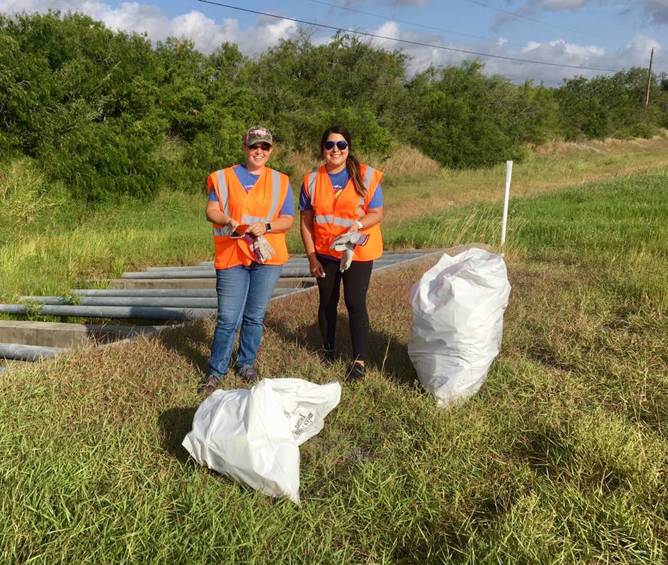 Employees picking up trash at Adopt-A-Highway