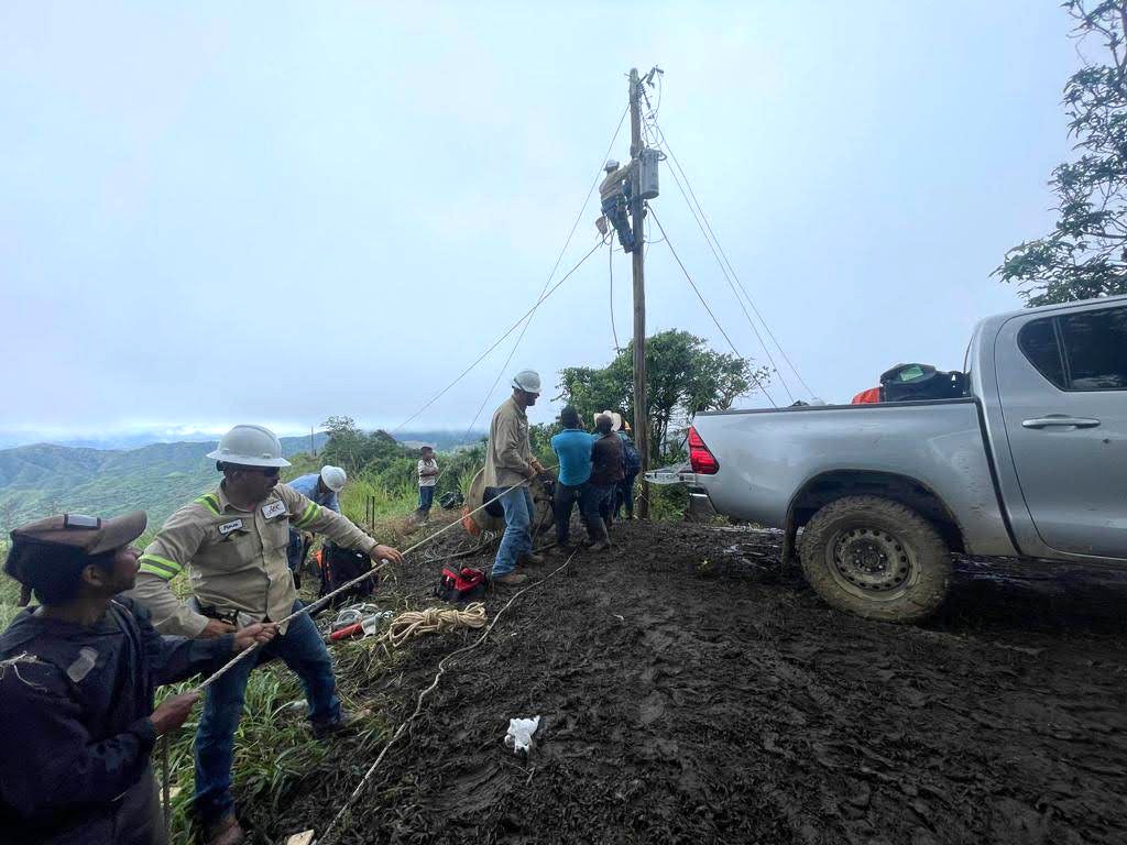 Linemen manually hang transformer in Guatemala