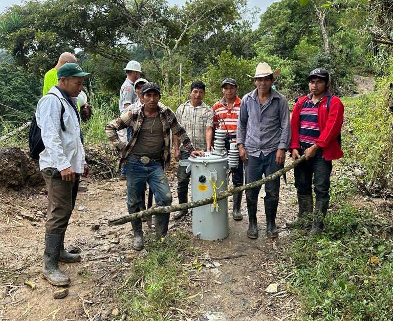 Guatemala locals carrying transformer